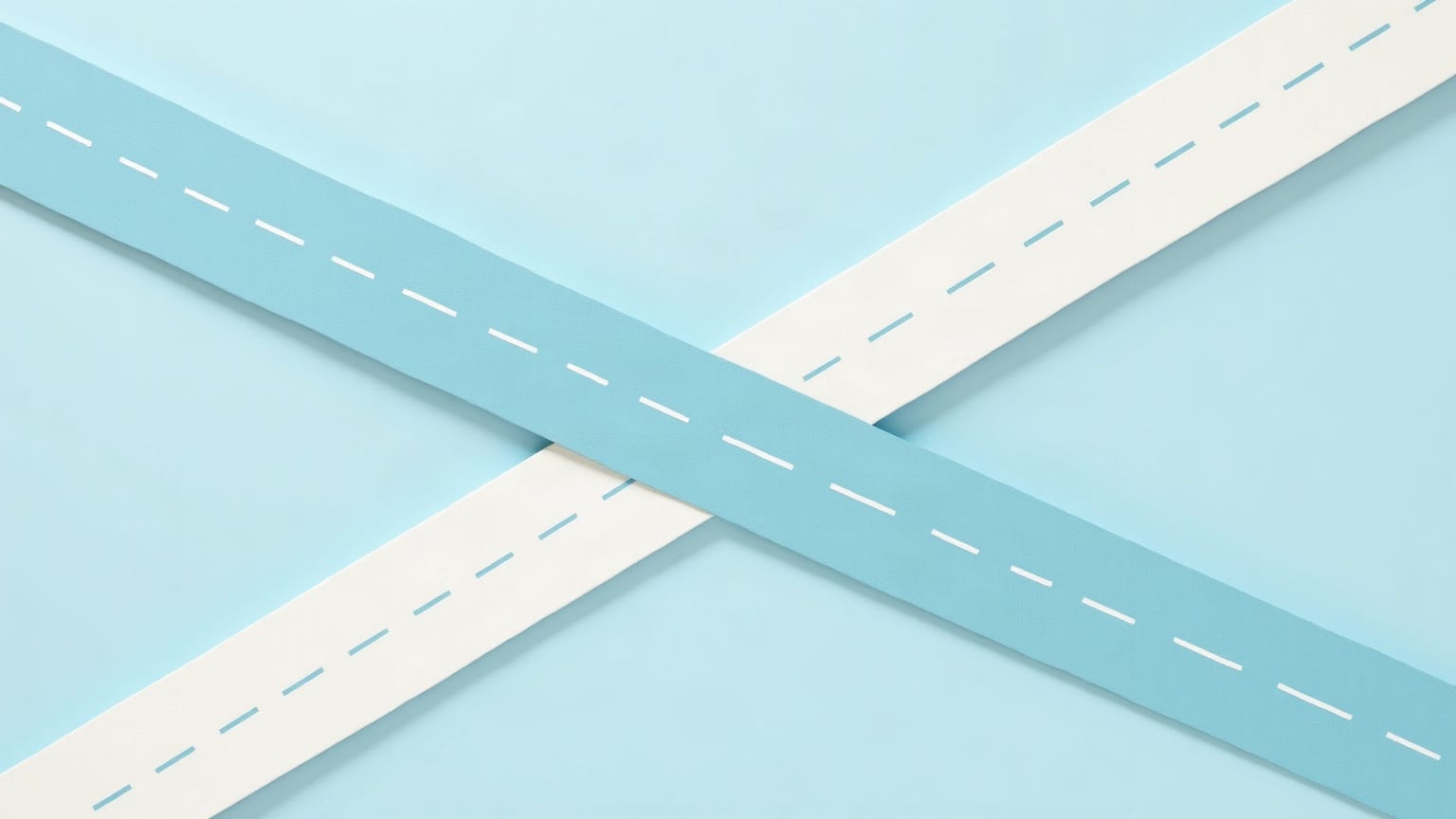 Two paper roads with dashed lane markings crossing at right angles on a clear mid-blue ground, the pale blue one carried over the chalk-white one on a ramp